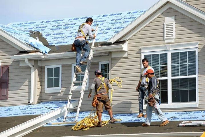 Dana K., roofing business owner, with crew on a roof